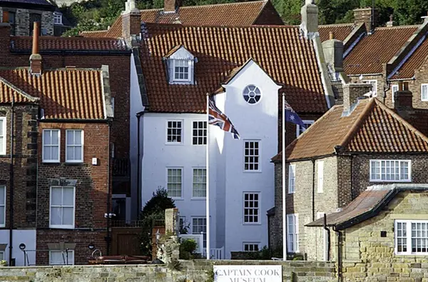 a white building with a flag in front of it